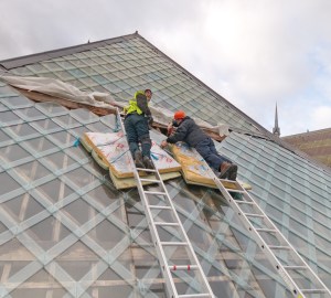 Stuart Knapp and Mike Peckett put the last tiles in place Credit: Stephen French