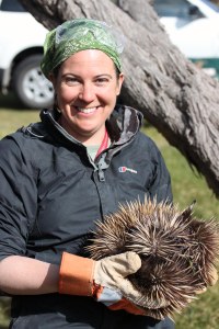Me, taking a break from fossil hunting to cuddle an echidna. 