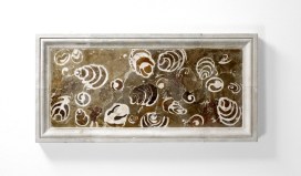 Marble-effect frame inlaid with a marble-effect stone showing the outline of numerous cross-section gastropod shells