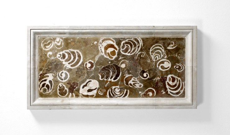 Marble-effect frame inlaid with a marble-effect stone showing the outline of numerous cross-section gastropod shells