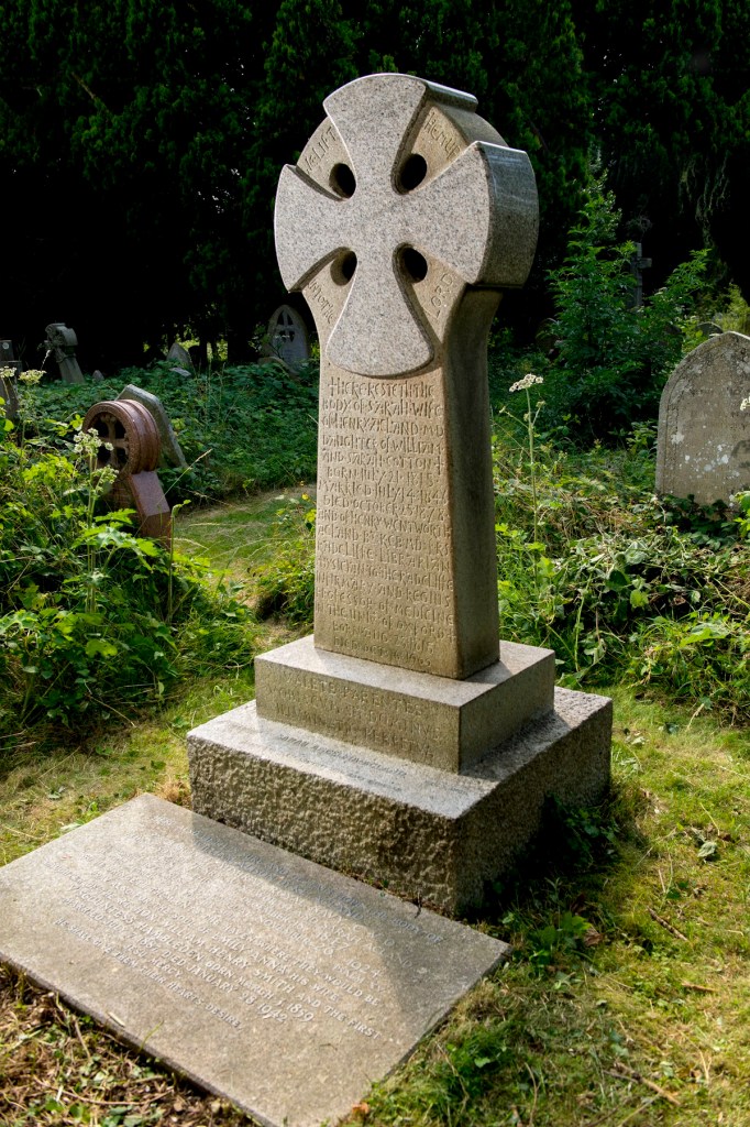 Headstone in grass cemetery