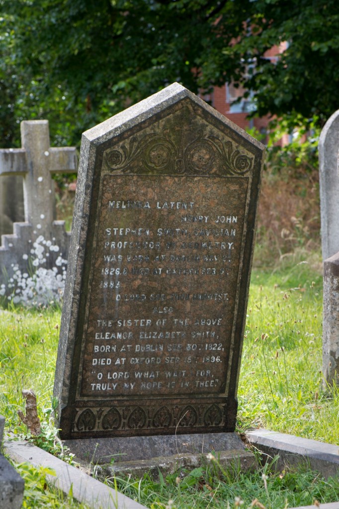Headstone in grass cemetery